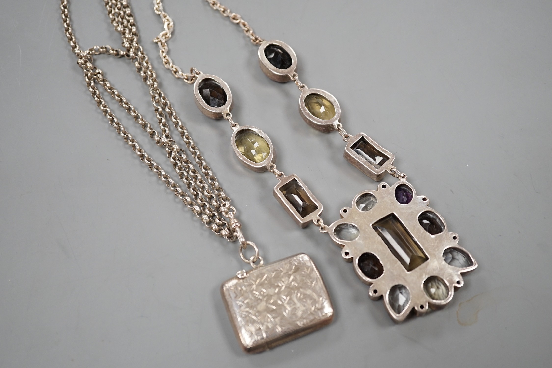 A large continental 925 white metal and multi-gem set rectangular pendant necklace, overall 72cm and a white metal double strand chain hung with a silver vesta case.